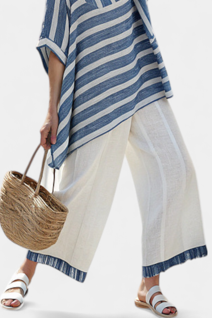 Elegant Mediterranean linen set with blue stripes and hem-finish trousers for a fresh, elegant look
