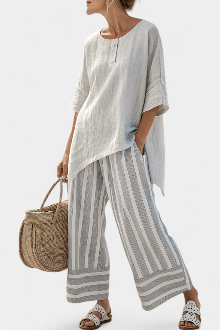 Daisy outfit with asymmetric blouse and striped trousers for a modern, elegant style