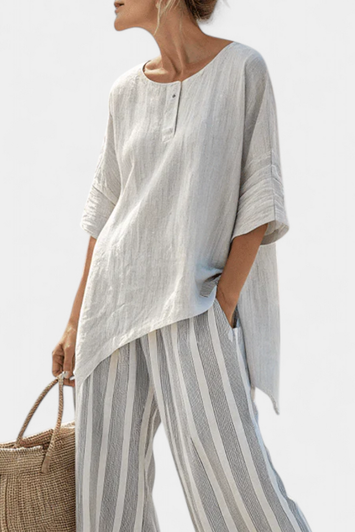 Daisy outfit with asymmetric blouse and striped trousers for a modern, elegant style