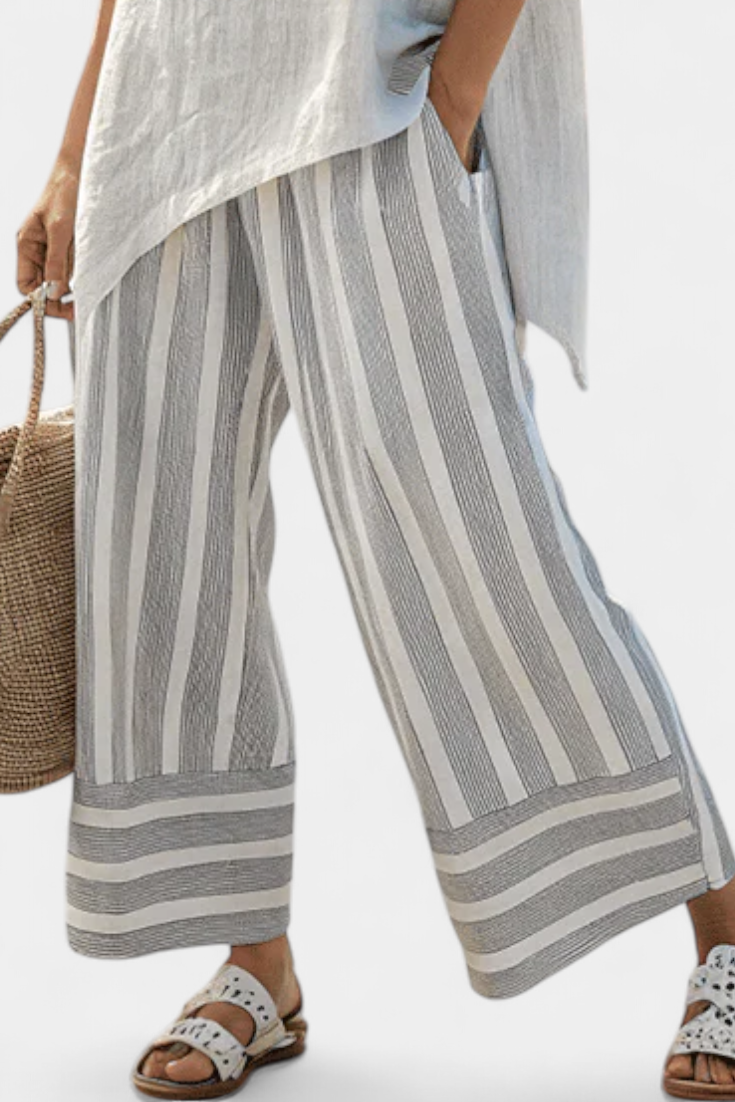 Daisy outfit with asymmetric blouse and striped trousers for a modern, elegant style