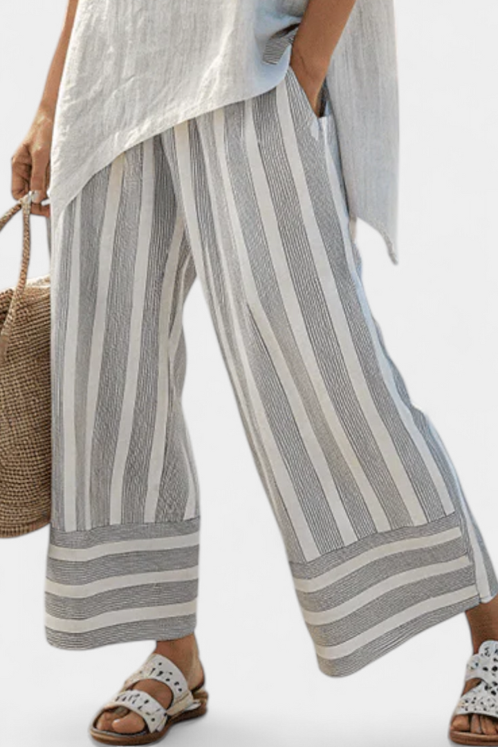 Daisy outfit with asymmetric blouse and striped trousers for a modern, elegant style